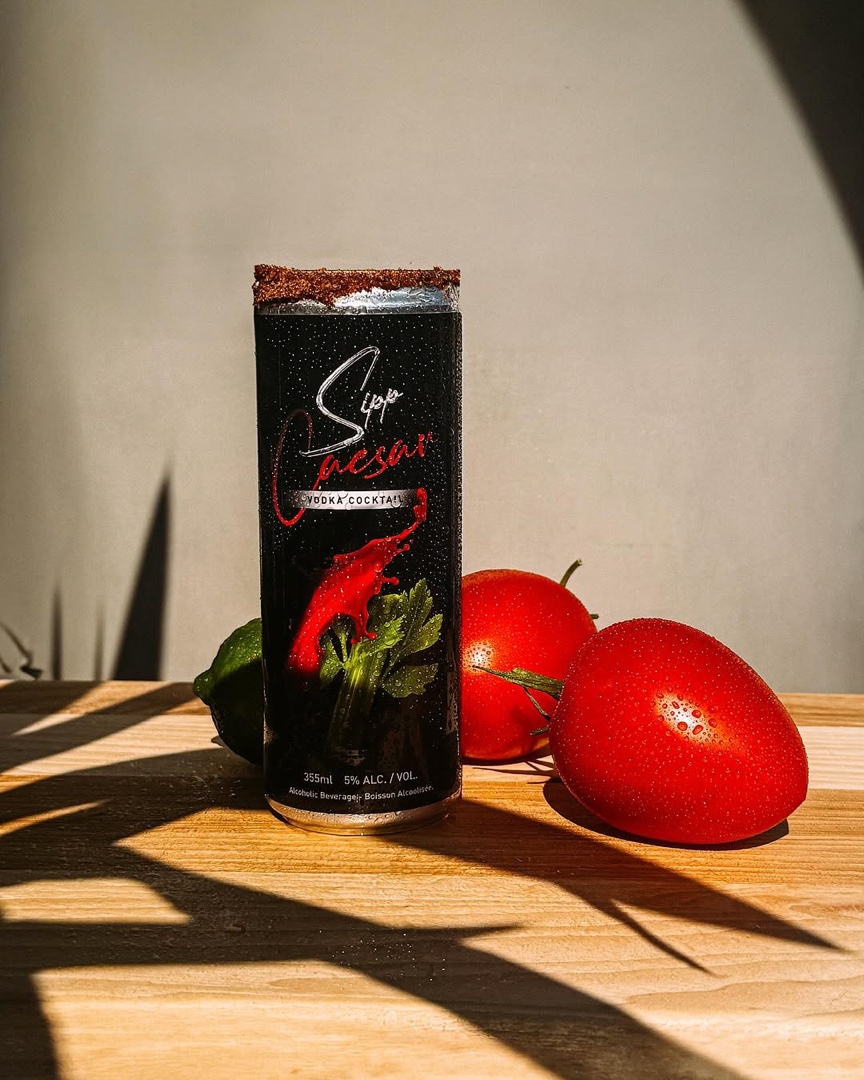 Sipp Caesar can in warm sunlight beside fresh tomatoes